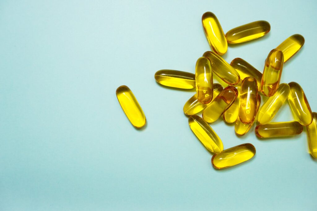 yellow capsules on blue surface. many have used such capsules for CBD for menopause.